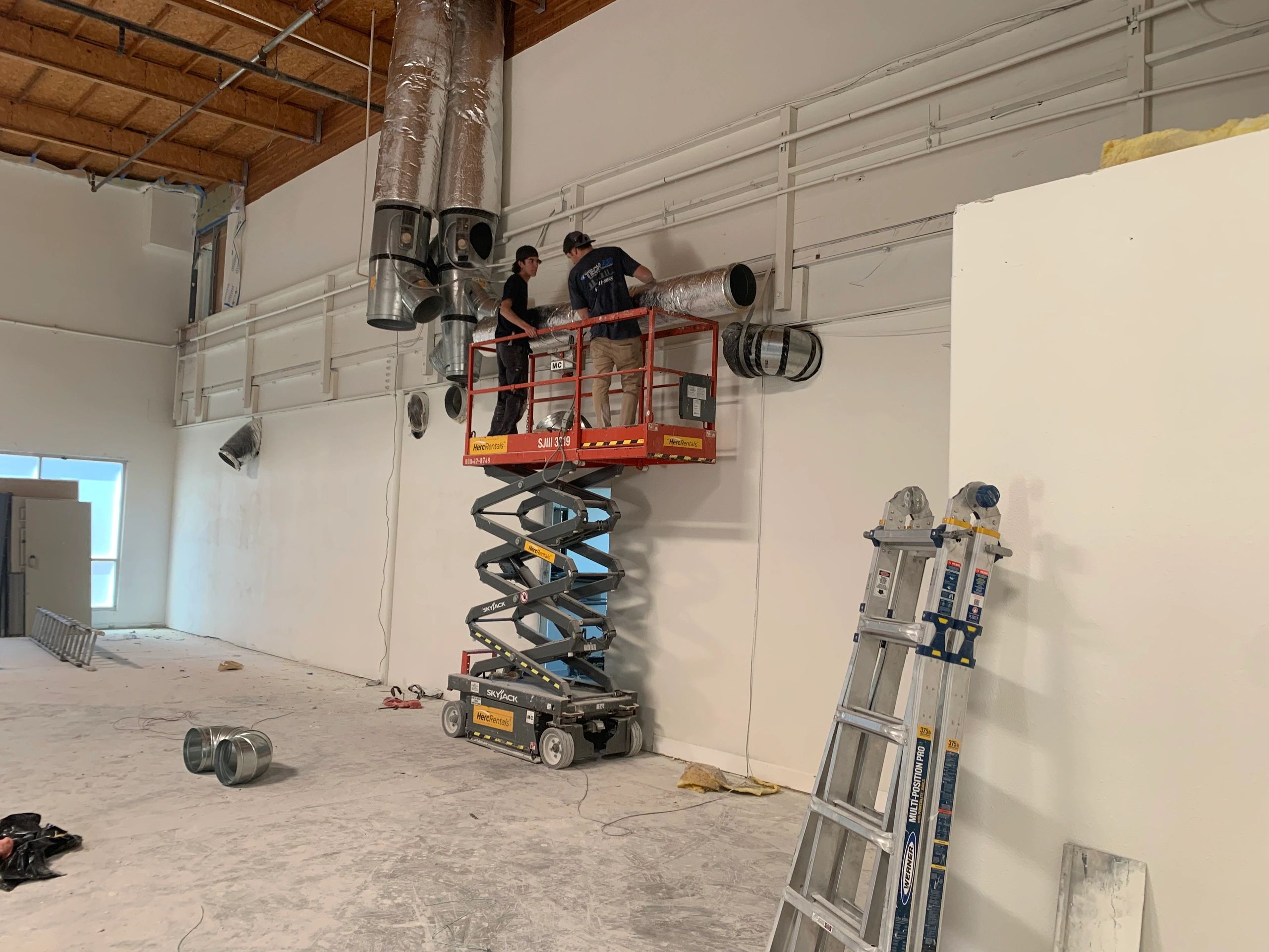 Construction site workers scissor lift